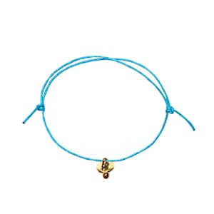 May include: A light blue string bracelet with a gold charm in the shape of a pacifier.