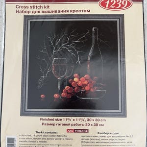 May include: A cross-stitch kit featuring a still life of a wine bottle, a glass of wine, and grapes. The finished size is 11.75 x 11.75 inches. The kit includes a color chart, black cotton fabric, yarn, metallic thread, and a needle.