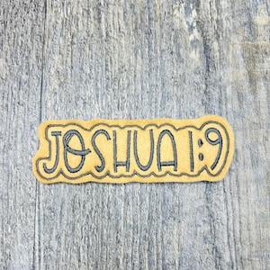 May include: A yellow felt patch with black embroidery that reads "Joshua 1:9".