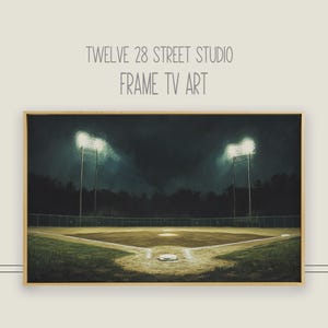 May include: A framed print of a baseball field at night with two bright lights illuminating the field. The field is empty and the grass is green.