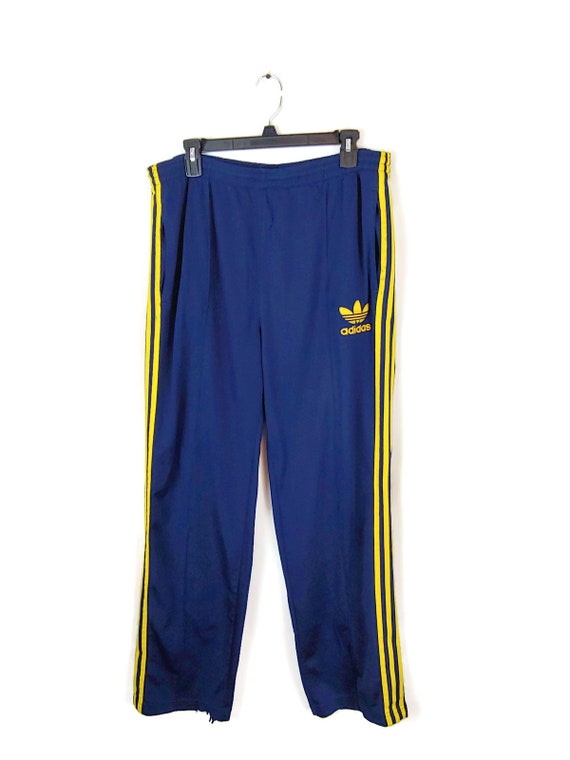 blue and yellow adidas track pants