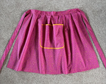 Ladies country style half apron bright pink with orange spot and trim.  Vintage retro style
