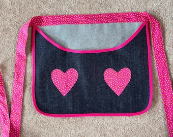 Apron style peg bag navy blue strong denim fabric with pink and yellow spotty heart decoration and tie belt