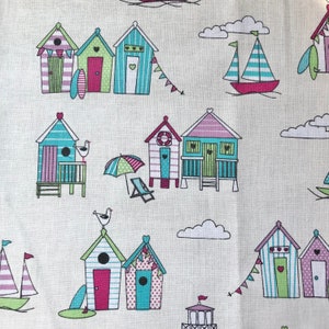 May include: A white background with a repeating pattern of colorful beach huts, sailboats, seagulls, and clouds. The huts are decorated with hearts, stripes, and polka dots.