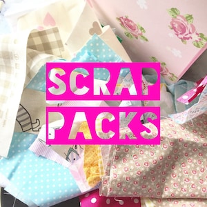May include: A collection of assorted fabric scraps featuring various patterns including light blue polka dots, beige gingham, pink floral prints, and heart motifs, with the text SCRAP PACKS overlaid in bold pink letters across the centre.