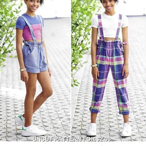 May include: A sewing pattern for two outfits. The first features a blue short-sleeved crop top with a pink chest panel and blue shorts with braces. The second features a white short-sleeved crop top and plaid trousers with braces.