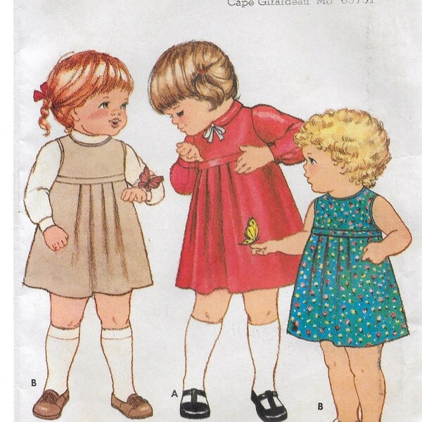 A Flared A-Line, Back Button, Raised Waist Long Sleeve Dress or Sleeveless Jumper Pattern for Toddlers: Size 1, Breast 20" • Butterick 3999