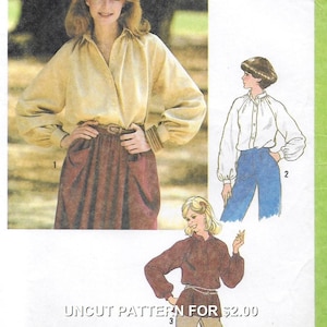 May include: A vintage sewing pattern showing a woman in a tan blouse and burgundy skirt. The pattern includes illustrations of different blouse styles. The text "UNCUT PATTERN FOR" is visible. The pattern is for making clothing.