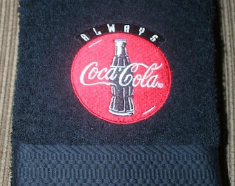 1 casquette brodée « inspiration Coca Cola » 1 essuie-mains noir