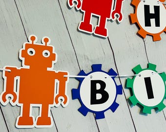 May include: A robot-themed birthday banner featuring orange and red robots and colourful gears with the letters "H", "B", and "I" on them.