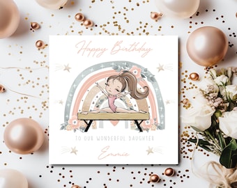 May include: A personalized birthday card featuring a cartoon girl gymnast performing on a balance beam in front of a rainbow with floral accents. The card says "Happy Birthday" and "To our wonderful daughter, Emmie".