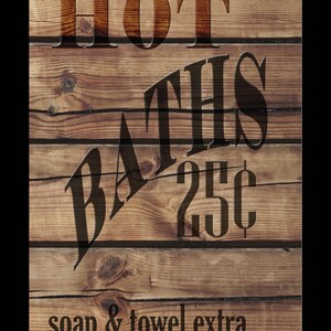 May include: A vintage wooden sign with the text "HOT BATHS 25¢ soap & towel extra". The sign is painted in brown and black.