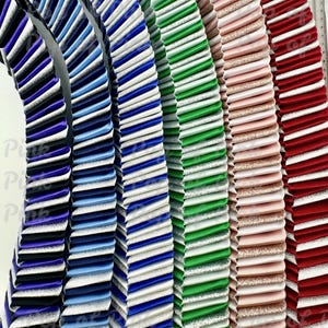 May include: A close-up of several colorful, pleated ribbons. The ribbons are arranged in a semi-circular pattern, showcasing a variety of colors including blue, green, pink, and red. Each ribbon has a textured, ribbed appearance, with some featuring glitter accents.