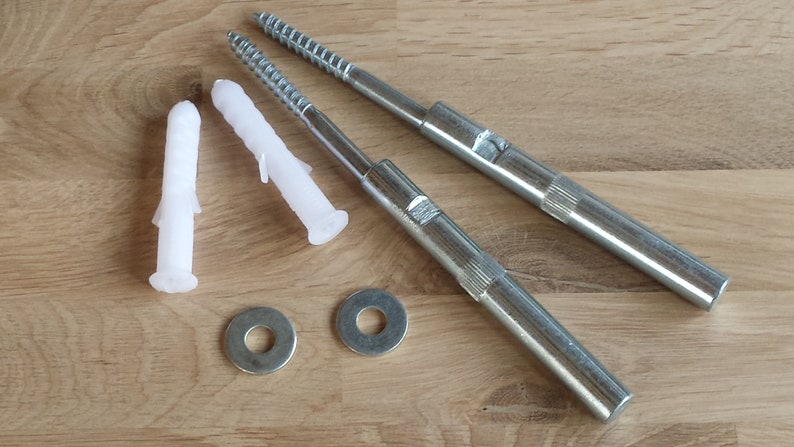 May include: Two silver metal screws with white plastic anchors and two silver metal washers. The screws are approximately 6 inches long.