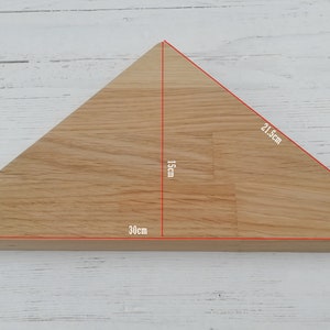 May include: A triangular wooden shelf with measurements of 21.5 inches by 30 inches by 15 inches.