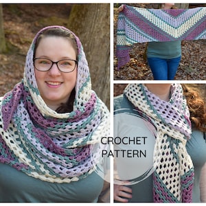 May include: A crochet shawl with a chevron pattern in shades of purple, green, and white. The shawl is draped over a person's shoulders and is being worn outdoors.