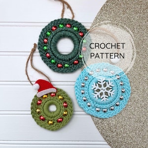 May include: Three crocheted Christmas ornaments, one green with red beads, one green with red and gold beads and a red Santa hat, and one light blue with silver beads and a white snowflake.