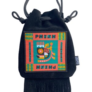 May include: Black suede drawstring bag with a fringe bottom. The bag features a colorful patch with the text "PHISH" and "SUMMER TOUR 2019" and a graphic of a stylized creature.