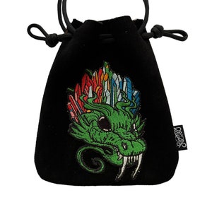 May include: Black velvet drawstring bag with a green dragon embroidered on the front. The dragon has colorful crystals on its head and a white background. The bag has a black drawstring and a black tag with the word "REZZ" on it.