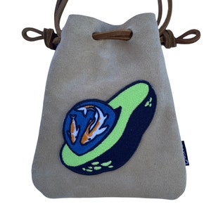 May include: A beige suede drawstring bag with a green, blue, and orange avocado patch featuring two fish. The bag has brown leather straps.