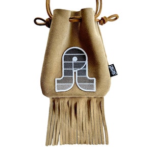 May include: A brown suede drawstring bag with a fringe bottom. The bag has a white and gray logo on the front that says "Oregon"