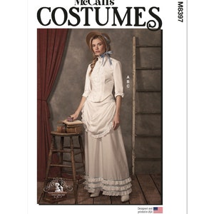 May include: McCall's Costumes sewing pattern for a vintage-style dress with a white blouse and a long skirt with ruffles. The pattern number is M8397. The model is wearing a white hat and a blue ribbon.