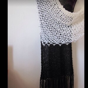 Cream shawl over a black dress, side view showing how the lightweight wrap drapes.