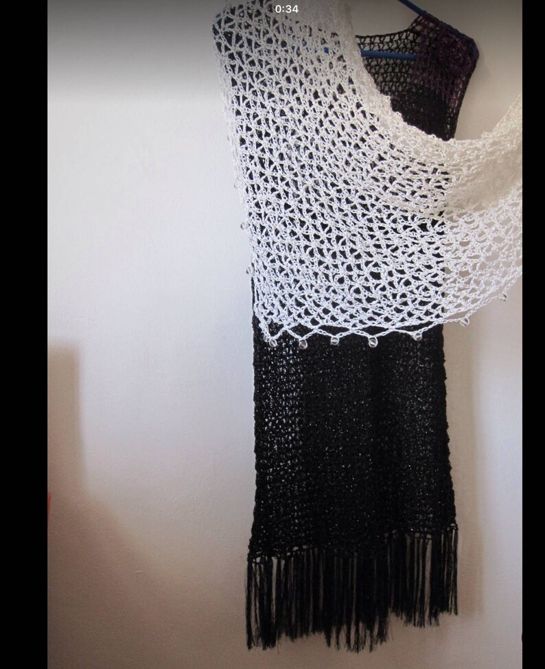 Cream shawl over a black dress, side view showing how the lightweight wrap drapes.
