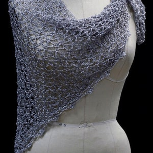Lightweight silver-white shawl draped on a dress-form mannequin against a dark background, front three-quarter view.
