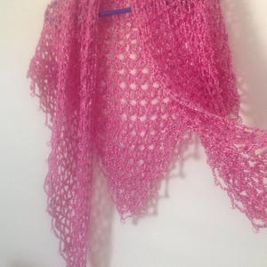Pink shawl on a hanger folded into a soft cowl, view of the neckline drape.