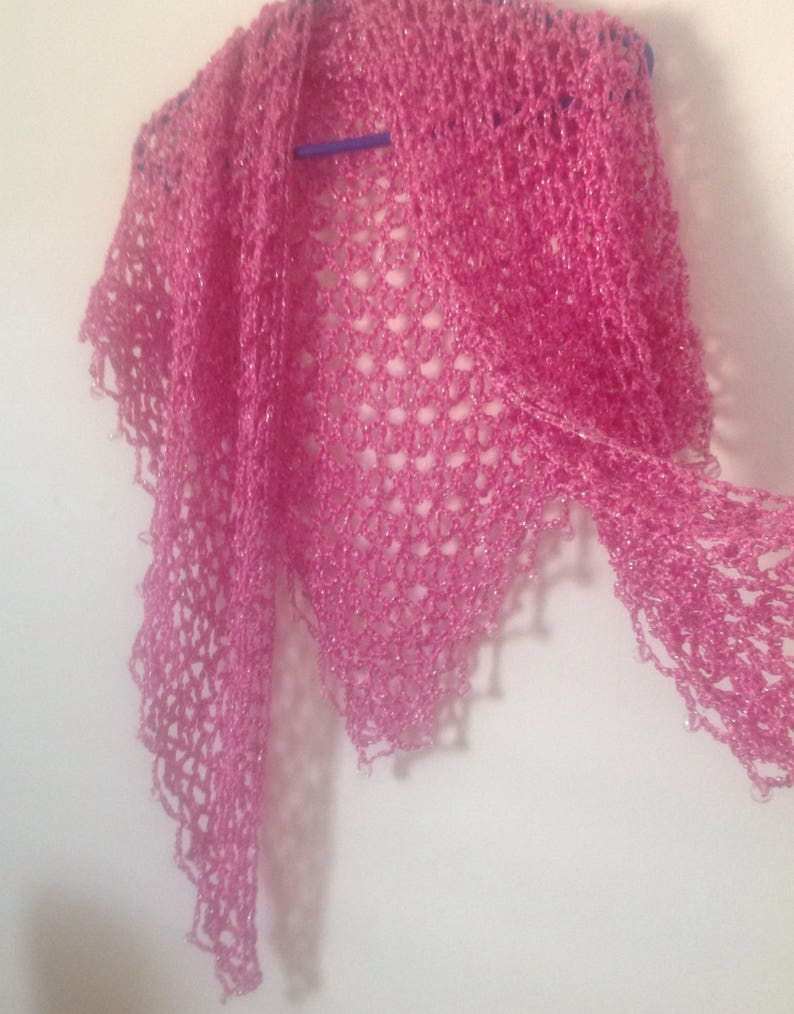 Pink shawl on a hanger folded into a soft cowl, view of the neckline drape.