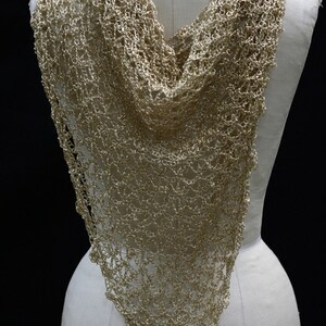 Back view of the gold lurex shawl on a mannequin, showing how the beaded triangle wrap falls down the back.