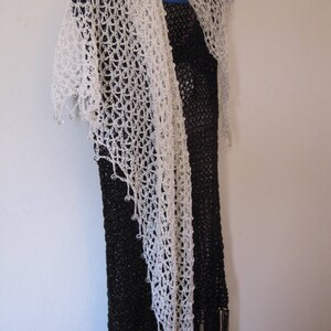 Cream crochet shawl over a black dress, alternate angle showing the soft drape.