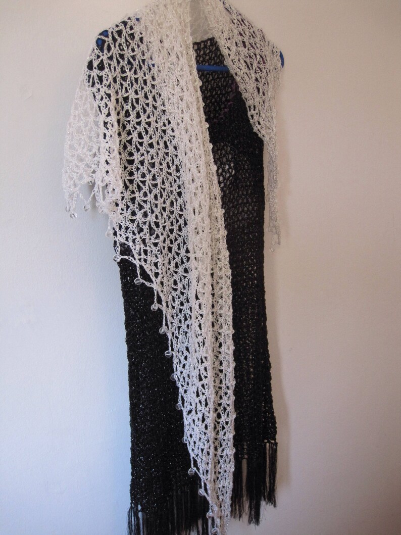 Cream crochet shawl over a black dress, alternate angle showing the soft drape.