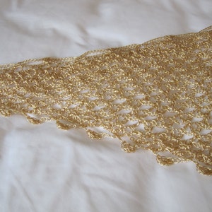 Close-up of the gold lurex crochet edge, revealing tight hand stitches and small beads along the scalloped trim.
