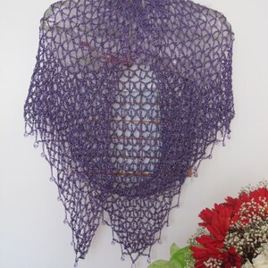 Purple lurex shawl centered in frame, front view of the even crochet and beaded hem.