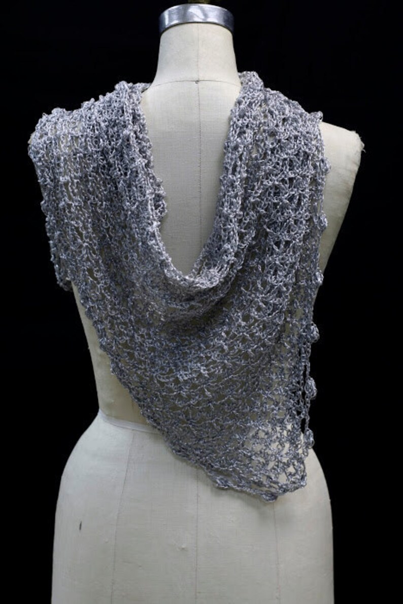Back view of the silver-white bridal shawl on the mannequin, the wrap falling softly down the back.