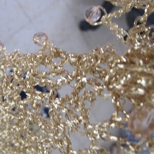 Close-up of the champagne shawl's beaded edge, clear beads set along the scalloped trim.