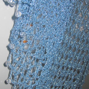 Close-up of the sky blue shawl's beaded edge, clear beads set along the scalloped trim.
