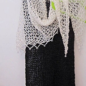 Cream shawl on a black dress, front view with the pointed hem falling center.