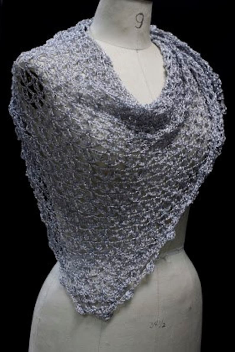 Front view of the silver-white shawl wrapped around the mannequin's shoulders.