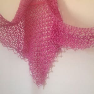 Pink shawl spread wide, showing the full width of the shimmering openwork.