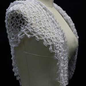 White shawl on the mannequin, alternate angle of the soft shoulder drape.