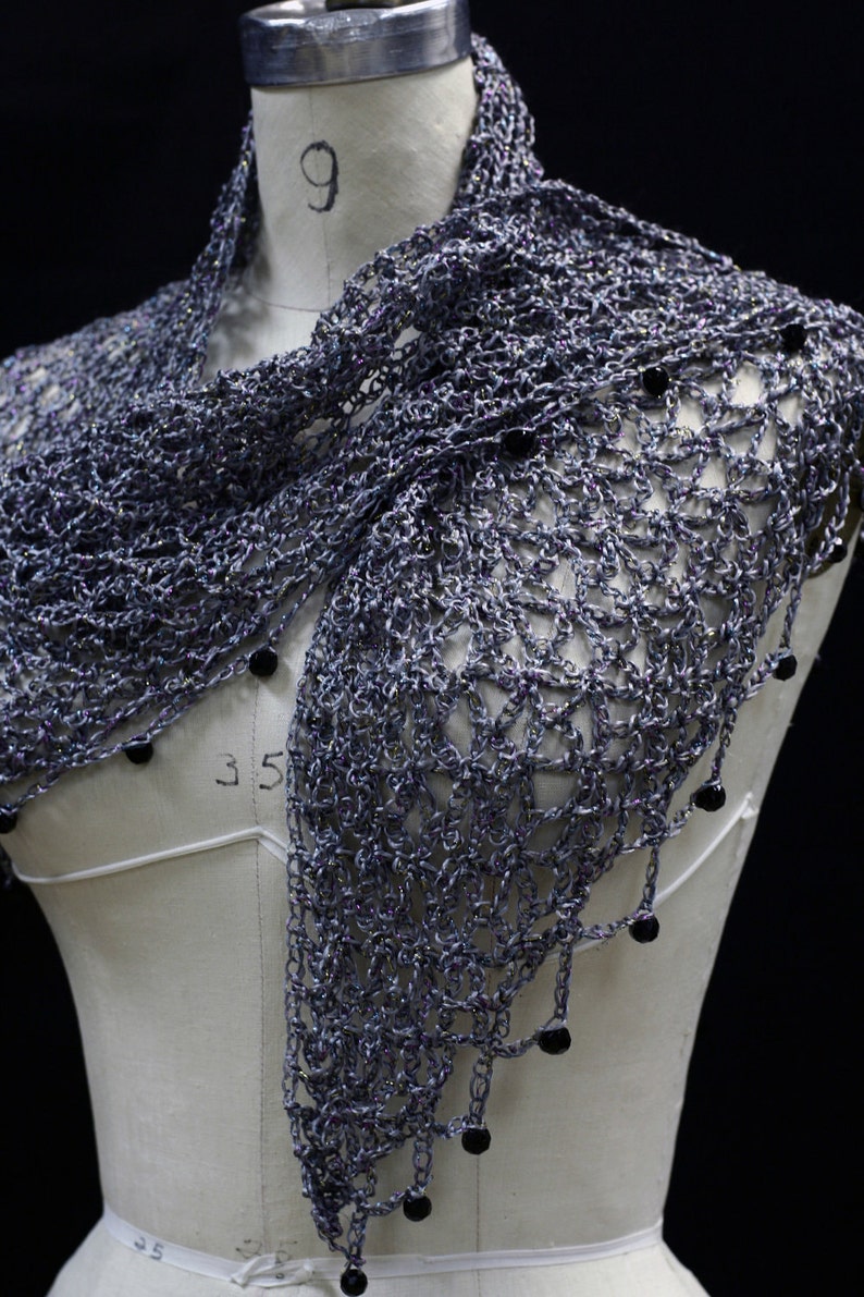Grey shawl on the mannequin, alternate front angle showing the openwork and bead trim.