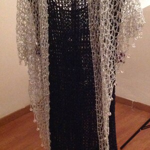 Silver beaded shawl over a black dress, alternate angle showing how the shimmering crochet falls along the body.