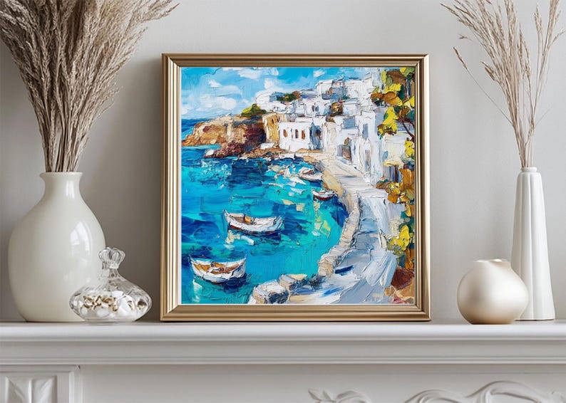 May include: A painting of a whitewashed village on a cliff overlooking a turquoise bay with boats in the water. The painting is framed in gold.