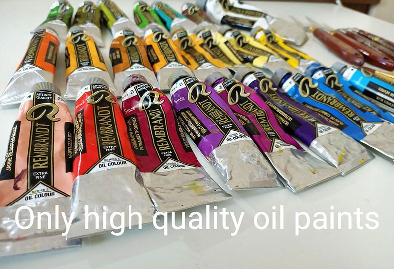 May include: A collection of tubes of Rembrandt oil paints in various colors, including pink, red, orange, yellow, green, blue, purple, and black. The tubes are arranged in a row on a white surface. The text "Only high quality oil paints" is visible at the bottom of the image.