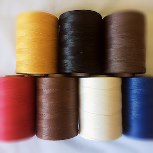 May include: Eight spools of waxed thread in various colours, including yellow, black, brown, red, dark brown, white, and blue.