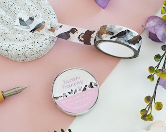 May include: A roll of washi tape featuring illustrations of various birds of prey, with a label reading Sarah Frances British Birds of Prey 10m Washi Tape. The tape displays detailed depictions of hawks, falcons, and eagles in flight and perched.