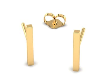 May include: A pair of gold bar stud earrings. The earrings are simple and minimalist, and they are perfect for everyday wear.